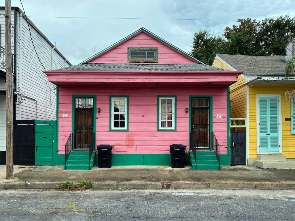 Pink shotgun house on a neighborhood street