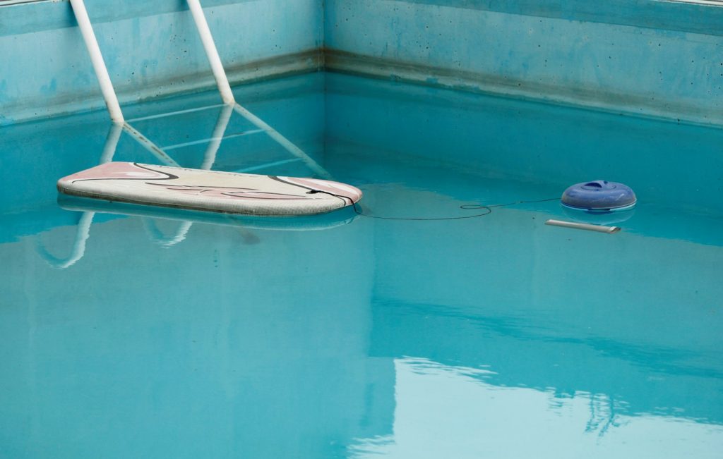 Pool skimmer net on the water surface
