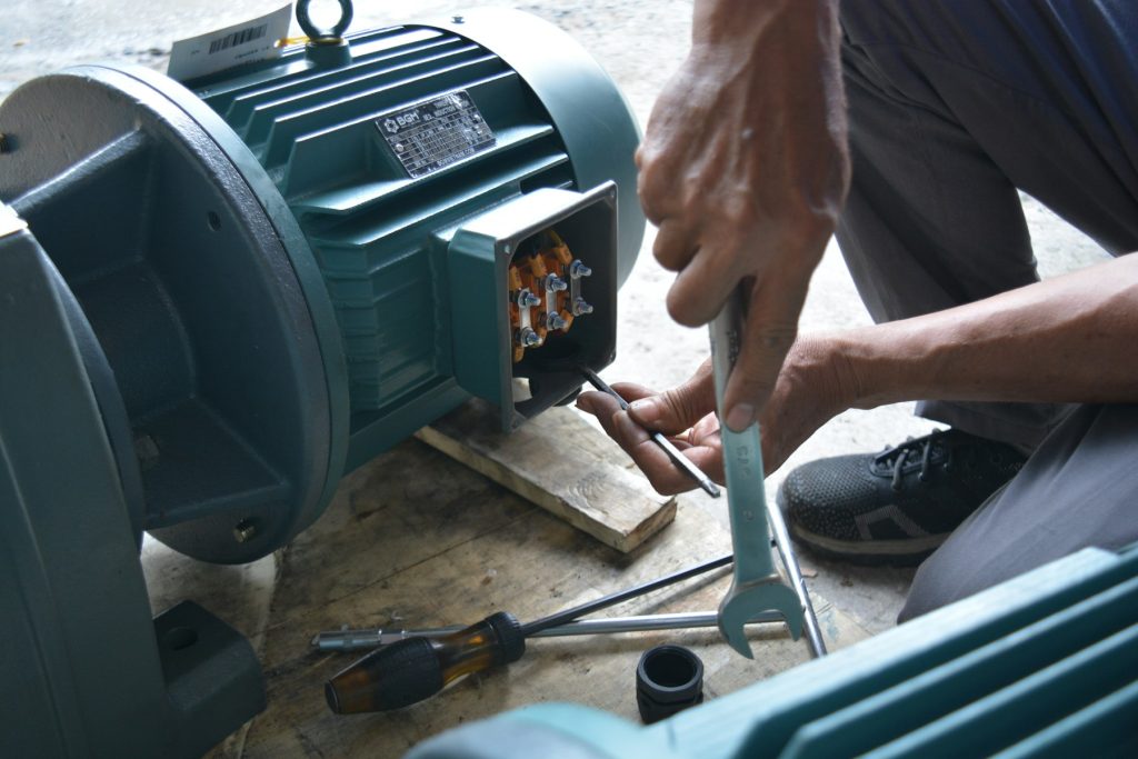 Technician repairing an electric pump motor